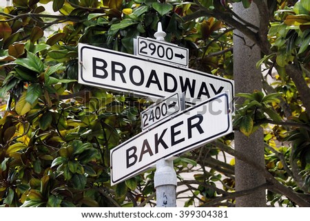 road sign with the words Broadway and Baker