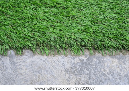 Abstract background with artificial grass on cement floor
