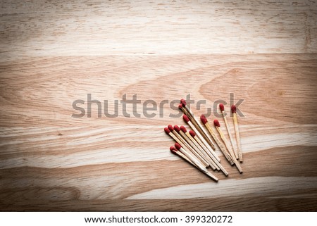 Match tool to ignite on wooden background