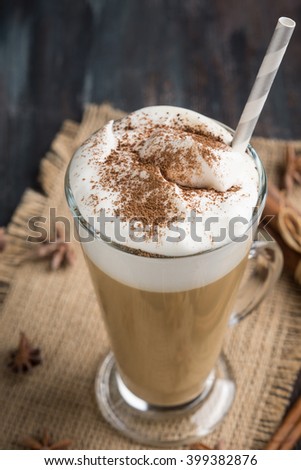 Coffee in glass on the wooden background. Shallow depth of field.