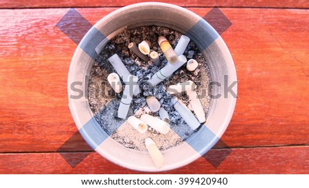 Cigarette Butts In Ashtray Sand cover with crosshairs