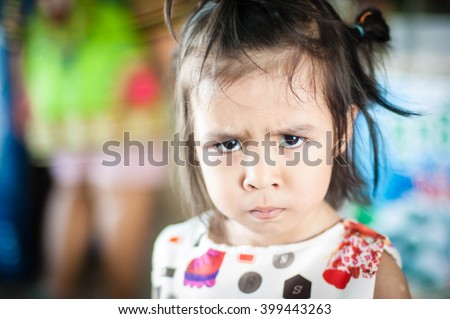 A young asian girl shows that she doesn't want to do what she is told Royalty-Free Stock Photo #399443263