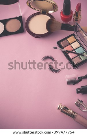 Various makeup products on dark background with copy space (Vintage with pink toned Style Color)