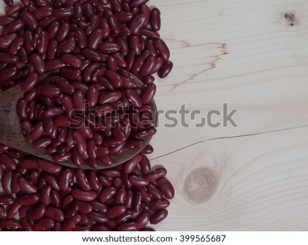 Red bean , Placed on a wooden spoon , on brown wood floor. (picture with space for text)