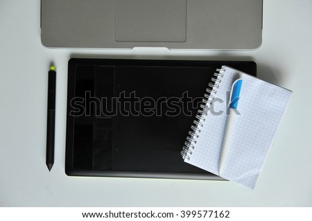 Designer's Desk: Laptop and Graphic Tablet. White background