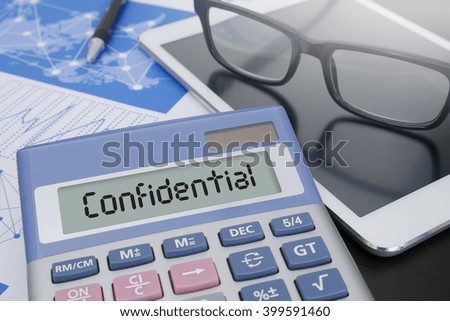 Confidential Concept  Calculator  on table with Office Supplies. ipad