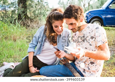 Beautiful couple taking a selfie having a picnic