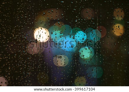 rainy days,rain drops on the window with traffic light background