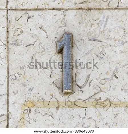 house number one on a stone wall