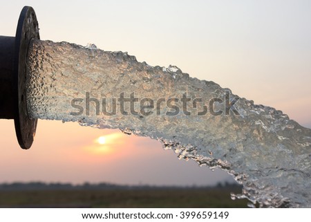 water flow from pipe , sunset and abstract Royalty-Free Stock Photo #399659149