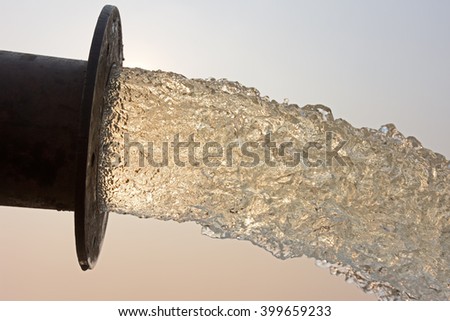 water flow from pipe , sunset and abstract Royalty-Free Stock Photo #399659233