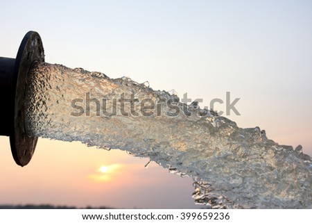 water flow from pipe , sunset and abstract Royalty-Free Stock Photo #399659236