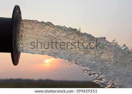 water flow from pipe , sunset and abstract Royalty-Free Stock Photo #399659251