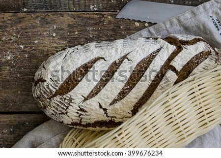 Assortment of baked bread on wooden table background. Bread basket.
