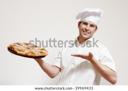  Portrait of happy attractive cook with a pizza in hands Royalty-Free Stock Photo #39969433