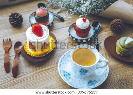 tea cup and cupcake and decoration placed on a wooden table ;Vintage style.