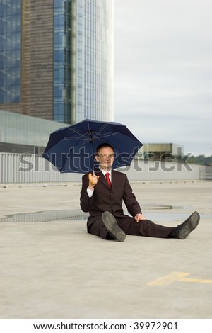 businessman sitting with umbrella (outdoor the office)