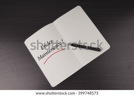 Under Maintenance written on notebook - business conceptual