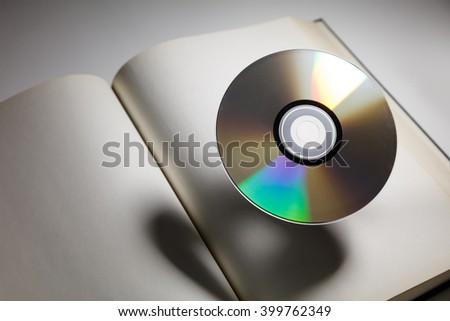 Book and DVD disk with dark shadow ,  education concept.