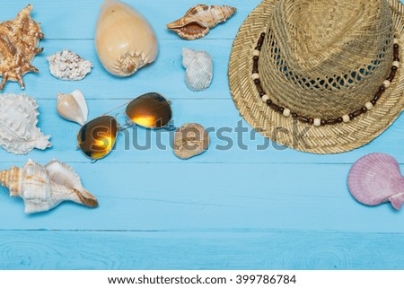 Summer beach accessories on blue wooden board