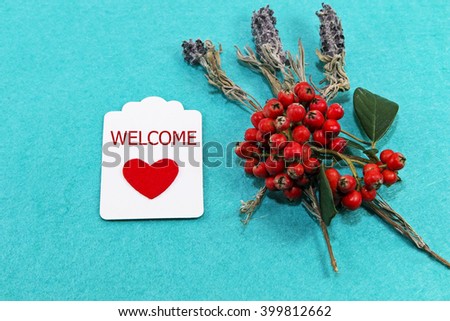 welcome text on red heart card and red flowers. retro