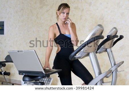stressed executive woman in the gym with lap top and phone