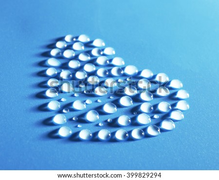 Heart made of water drops on blue background