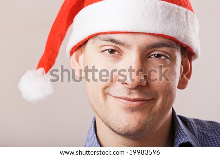 Young man in Santa hat and blue shirt portrait