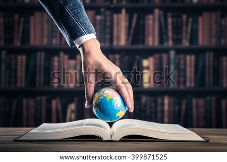 Heavy book and globe