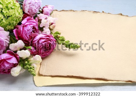 Vintage sheets of paper and bouquet of flowers, copy space. Blank space for greetings.