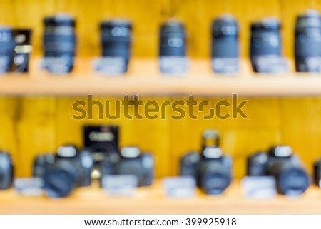 Blurry cameras and lenses in camera store shelf. Great image for your background