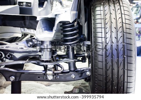 Front wheel of drive car with new tire and Shock Absorber Royalty-Free Stock Photo #399935794