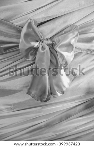 Beautiful fabric bow, Vector illustration. Curtains for decoration, advertising labels. Stage Curtain. Drapery With a bow. Cards, labels in a wave-like fabrics. Black and white color