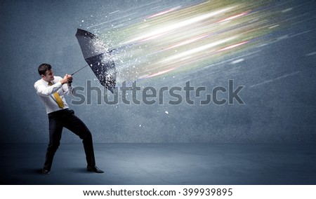 Business man defending light beams with umbrella concept on background