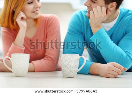 Young beautiful couple with cups of tea, close up