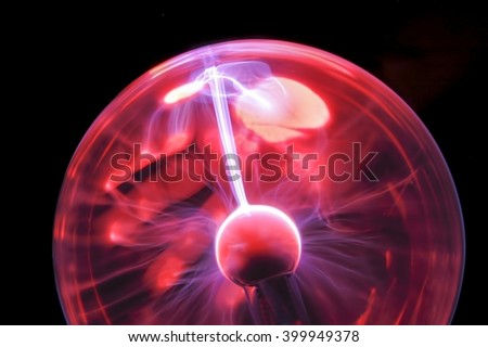 Plasma ball with glowing steaks of white hot plasma trailing round glass ball
