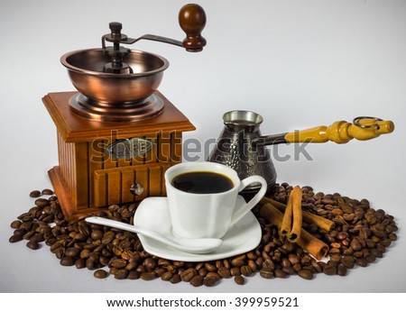 Still life with coffee attributes. Coffee grinder,  Cup, coffee beans.