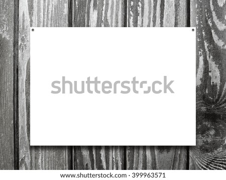 Close-up of one nailed blank poster frame on monochrome wooden background