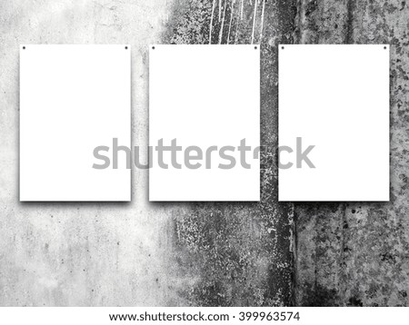 Close-up of three nailed blank frames on weathered wall