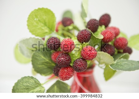 bouquet of red berries in a vase