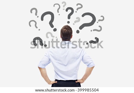 rear view of a caucasian business person looking at the question marks on white board. Royalty-Free Stock Photo #399985504