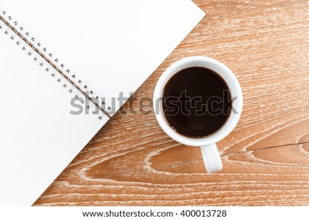 notebook and coffee on wooden background