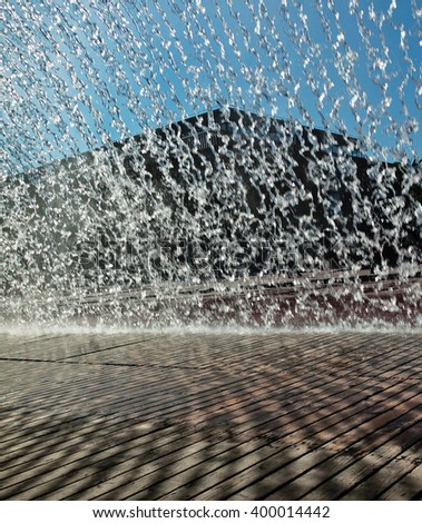 Splashes of fountain water in a sunny day near the oceanarium in Lisbon - Portugal