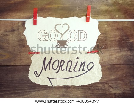 piece of paper with text "good morning" on the wooden. toned sun light image