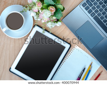 Top view of worktable with laptop, tablet & cup of coffee on wooden background/ business conceptual