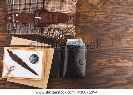 Vintage set of clothes and home items, wooden background  