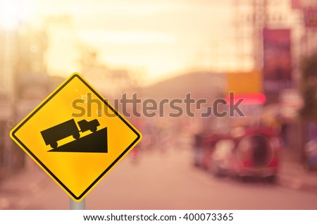 Traffic sign, up hill on blur road background. Retro color style.