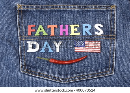 USA Flag Label And Colorful Wooden  Father's Day Sign On The Blue Jeans Back Pocket Background, Close Up