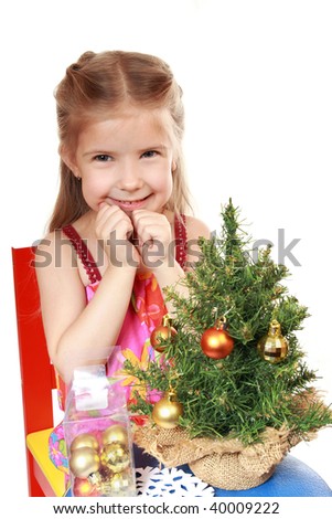 Enthusiastic girl dresses up Christmas tree