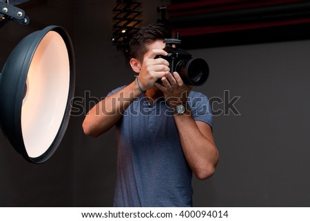 photographer with a medium format camera in the studio